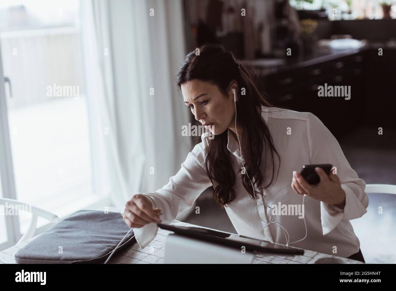 Businesswoman using digital tablet while working at home office Stock Photo