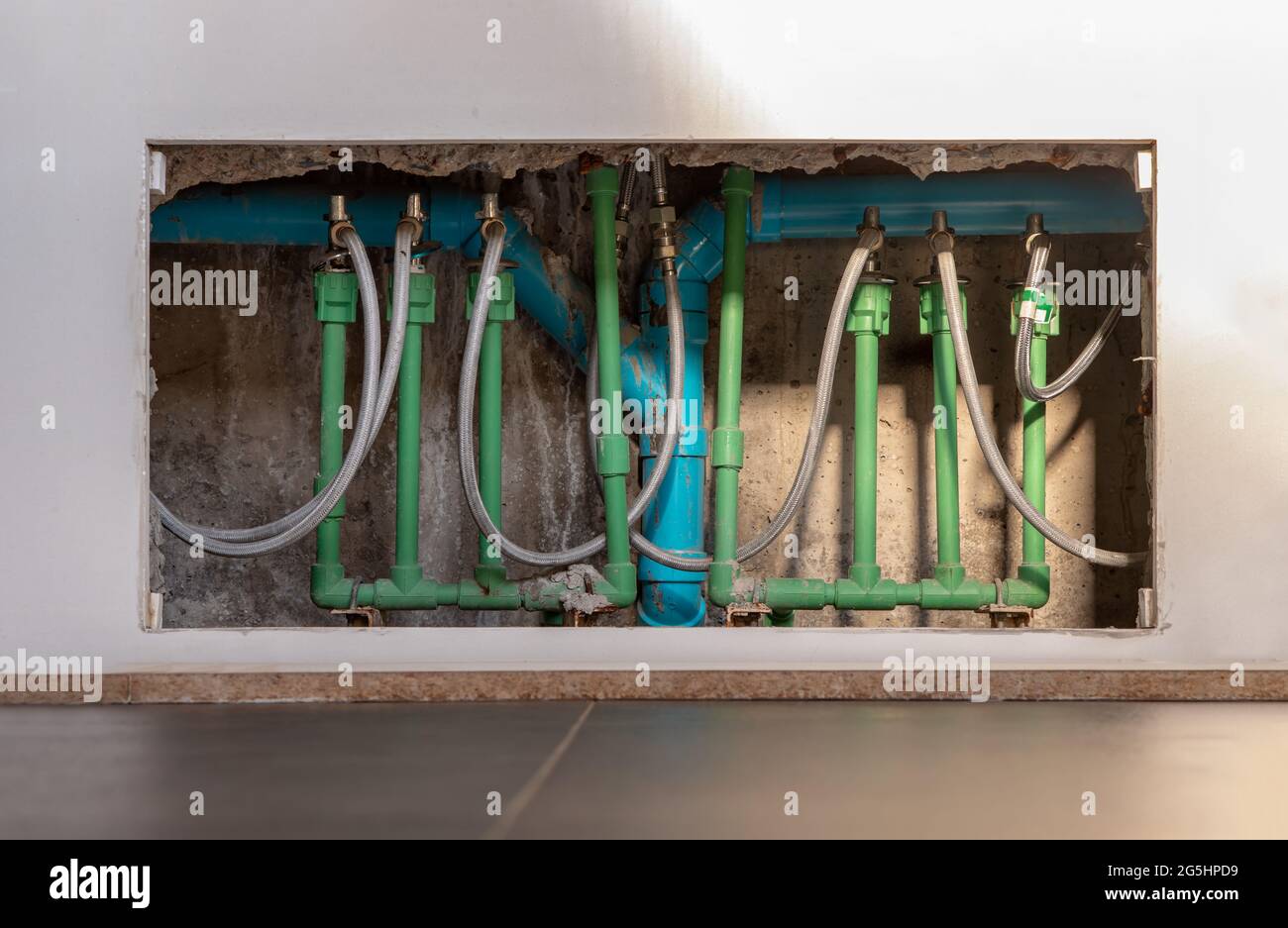 Detail of the plumbing system under the bathroom washbasin. Pipes
