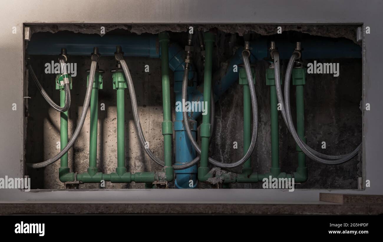 Detail of the plumbing system under the bathroom washbasin. Pipes