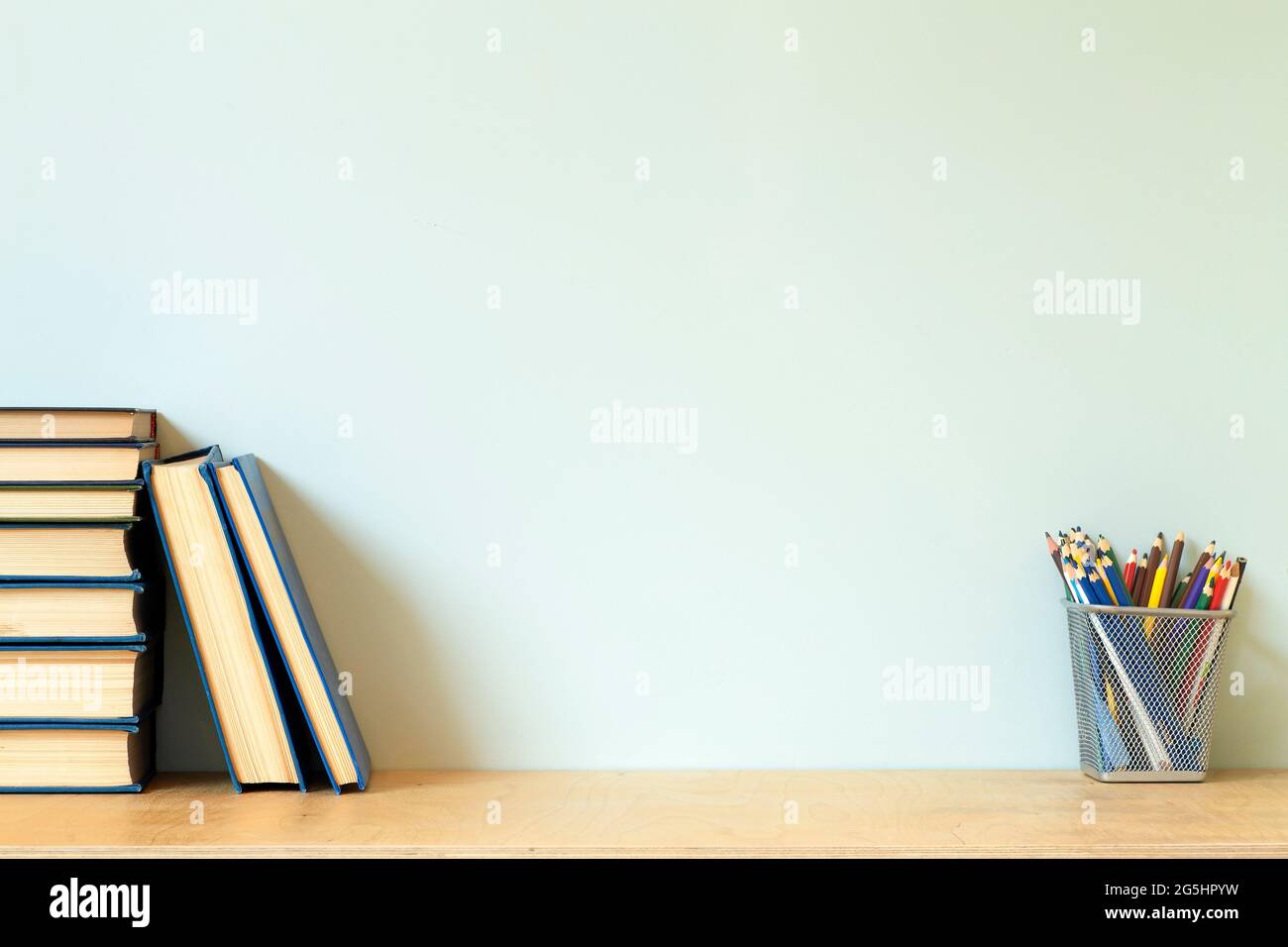 Home office desk table background. Empty wall with wooden table with  stationery and books for work or study. High quality photo Stock Photo -  Alamy