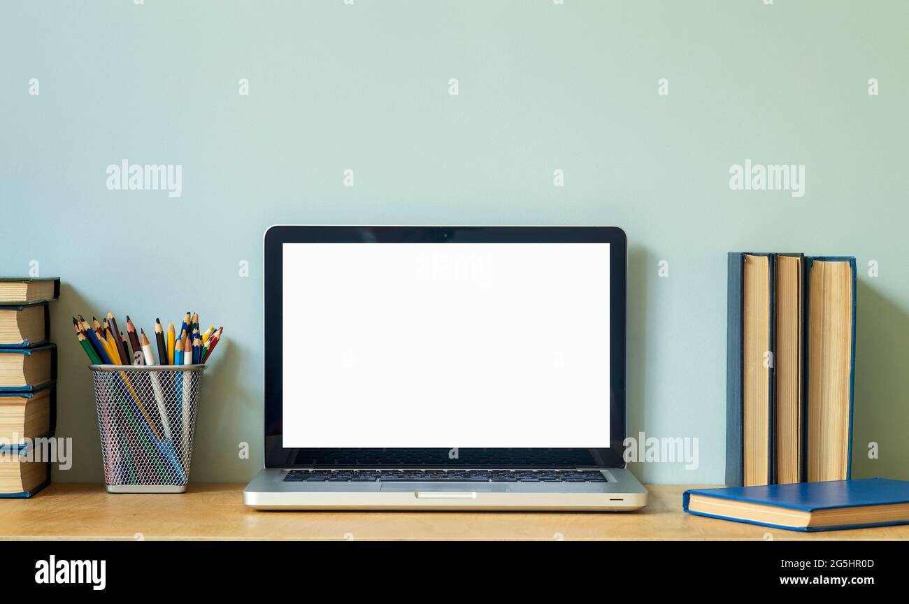 Home office desk table background. Empty laptop screen pc on the wooden  table with books for work or study. High quality photo Stock Photo - Alamy