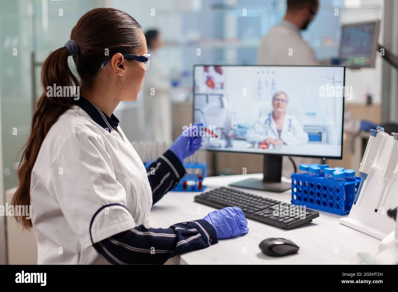 Scientist listening professional doctor on video call, during virtual ...