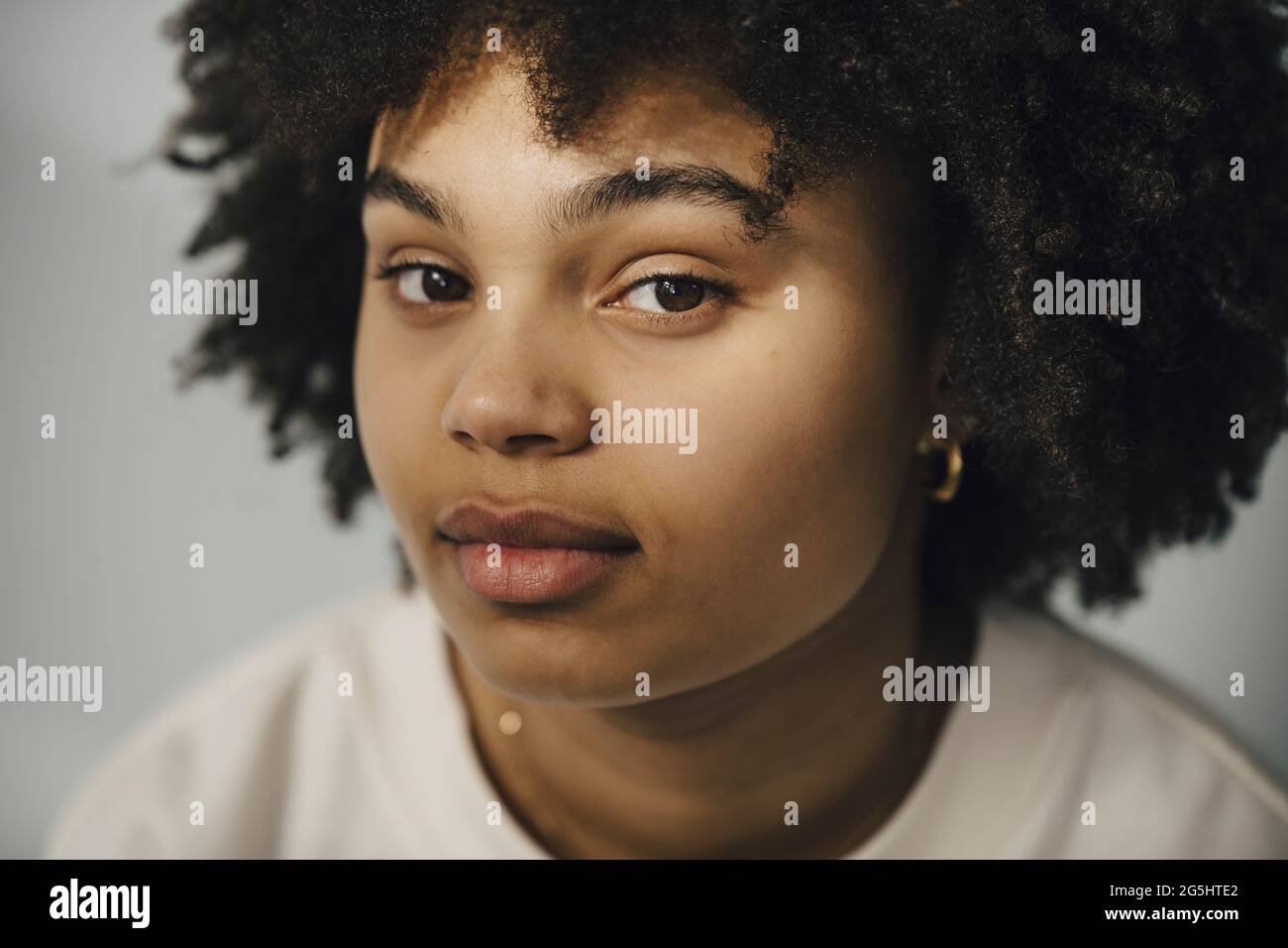Young woman with black curly hair Stock Photo
