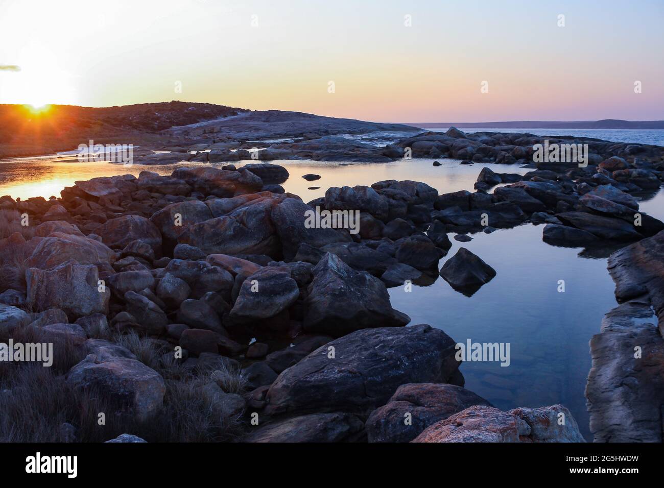 Landscape view of rockpools at sunset, taken at Two People's Bay in Western Australia's Great Southern Region. Stock Photo