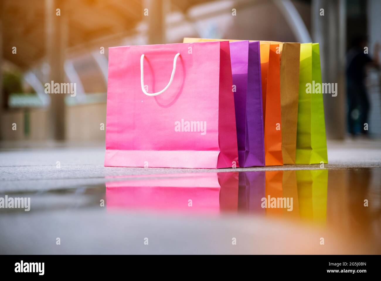 Shopping bags of women crazy shopaholic person at shopping mall indoor. Fashionable Woman love online website with sales tag on black friday. E-commer Stock Photo