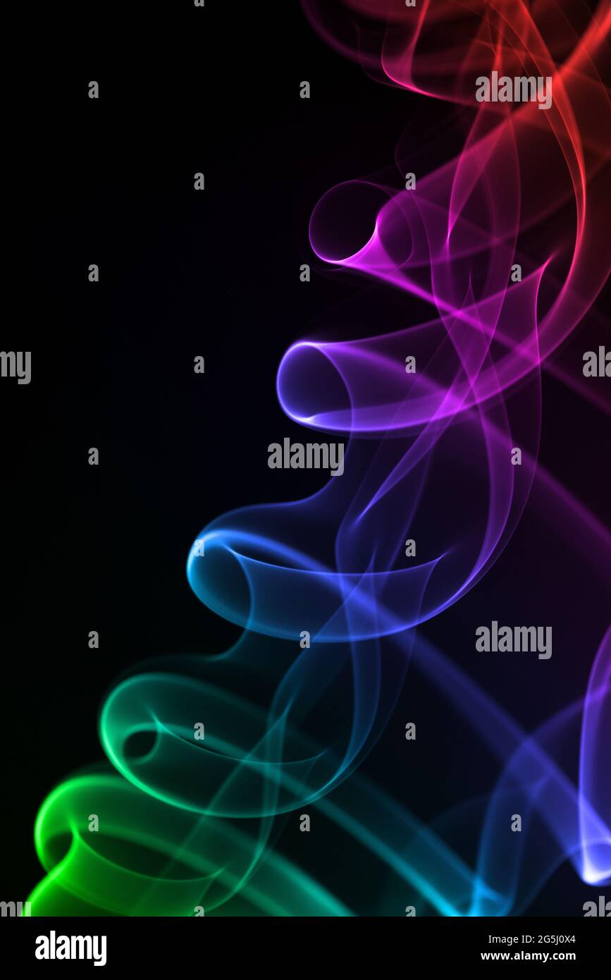 Colorful smoke isolated on black background. Stock Photo