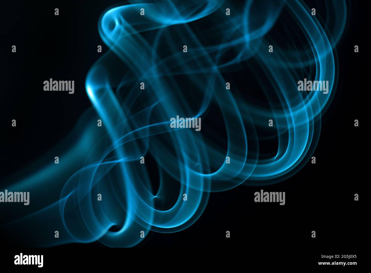 Blue smoke isolated on black background Stock Photo - Alamy