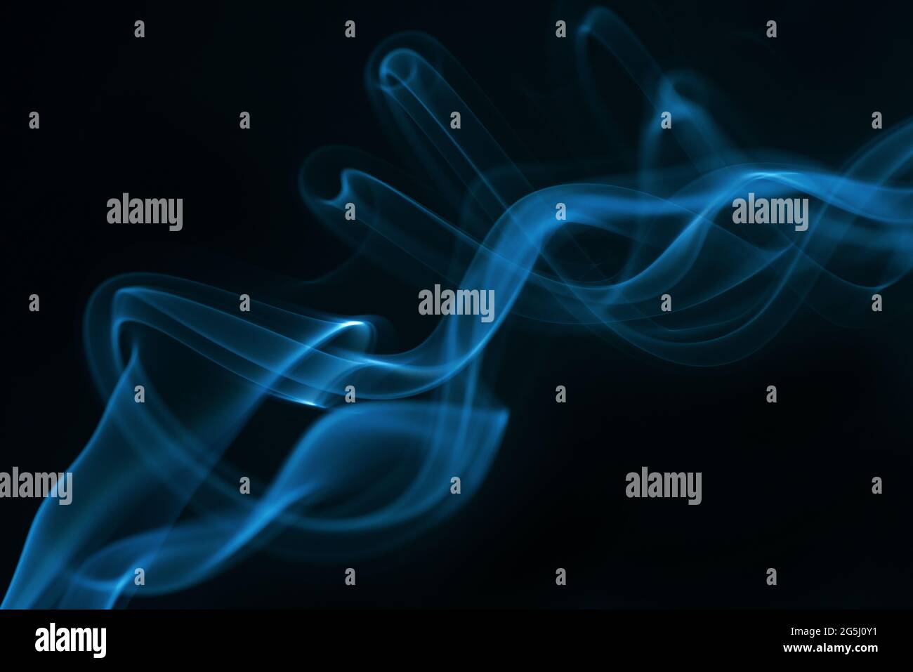 Blue smoke isolated on black background. Stock Photo