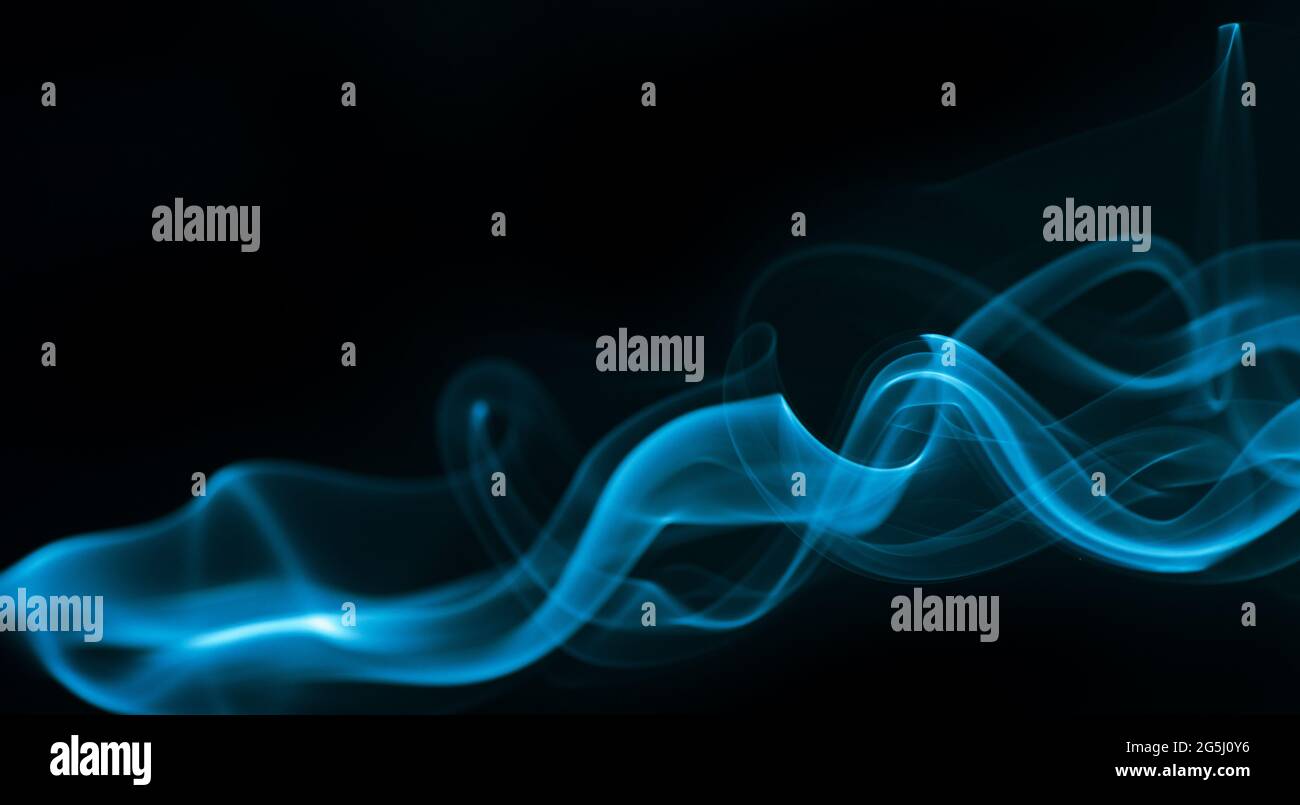 Blue smoke isolated on black background. Stock Photo