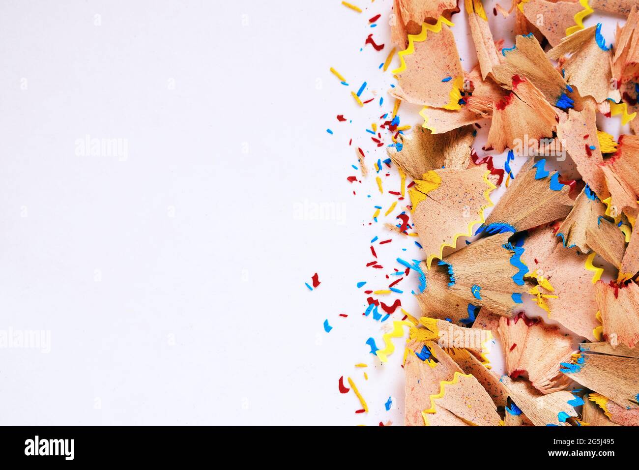 Wood shavings of a pencil and pieces of graphite from a sharpener - Shavings and copy space on a white background for text - Concept of creative proje Stock Photo