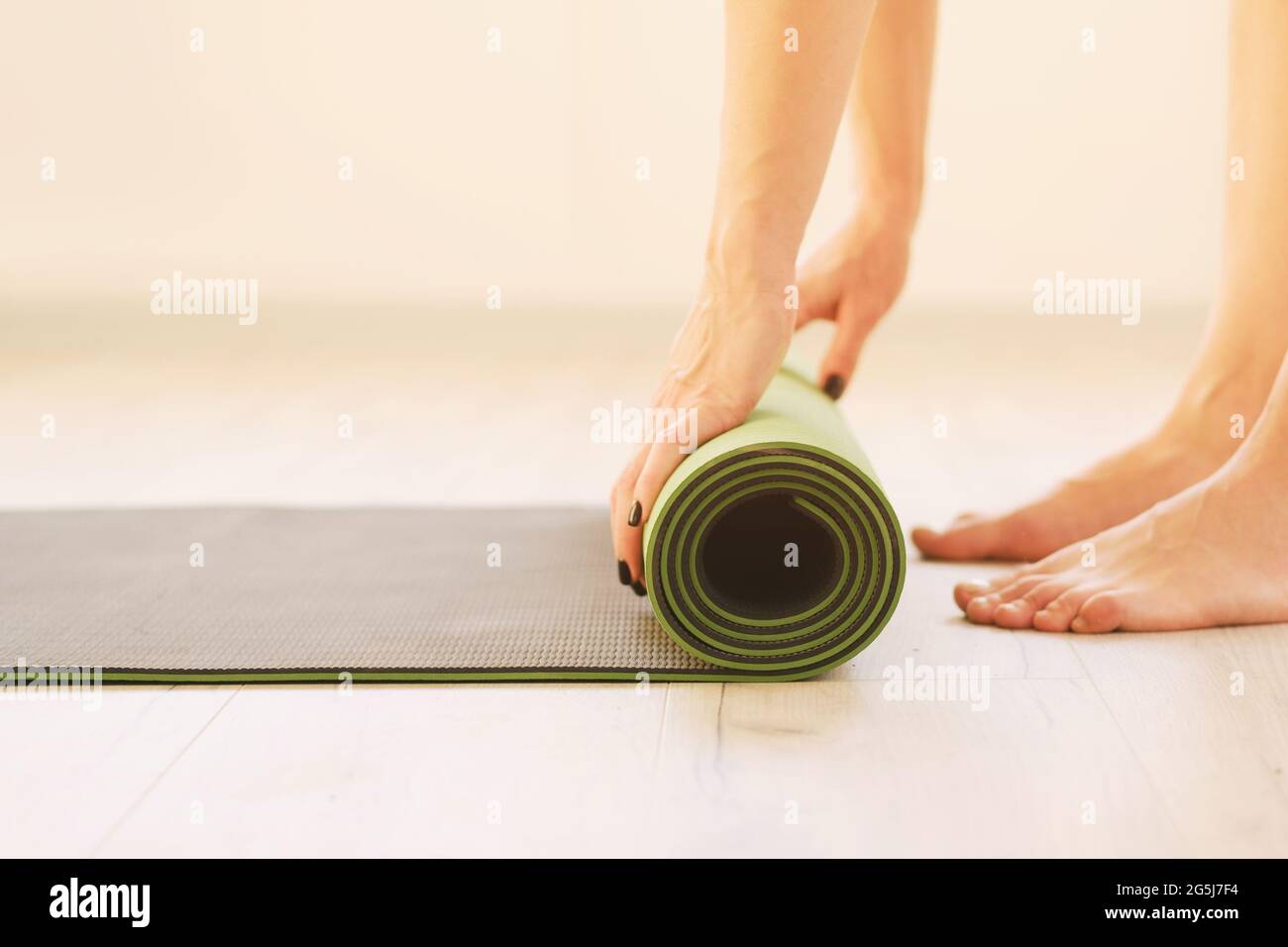 Healthy lifestyle Girl uses yoga mat Roll of sports mat closeup