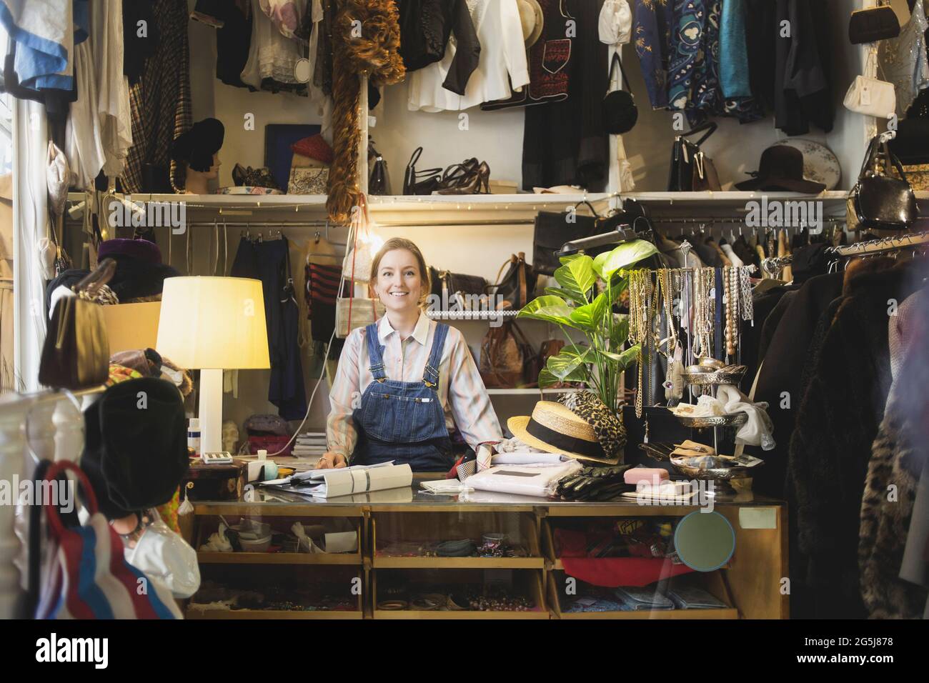 Caucasian female owner standing at counter in boutique Stock Photo