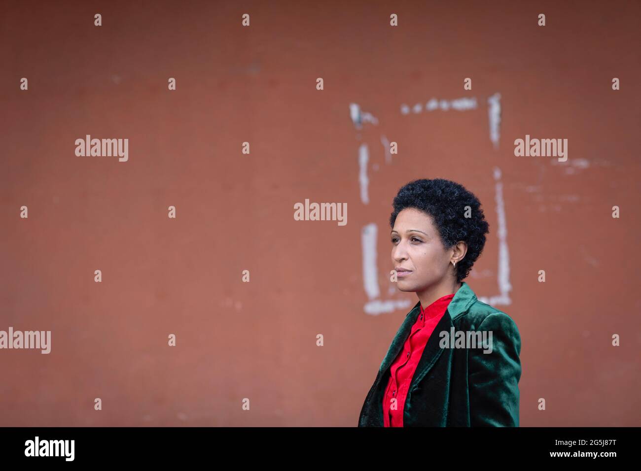 Italy, Tuscany, Pistoia, Woman in metallic blazer standing against wall Stock Photo