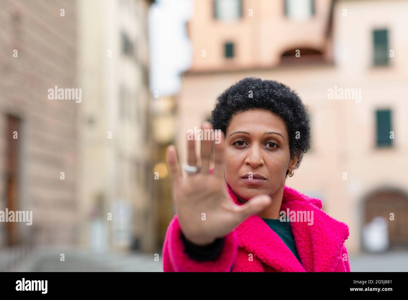 Italy, Tuscany, Pistoia, Woman making stop gesture Stock Photo