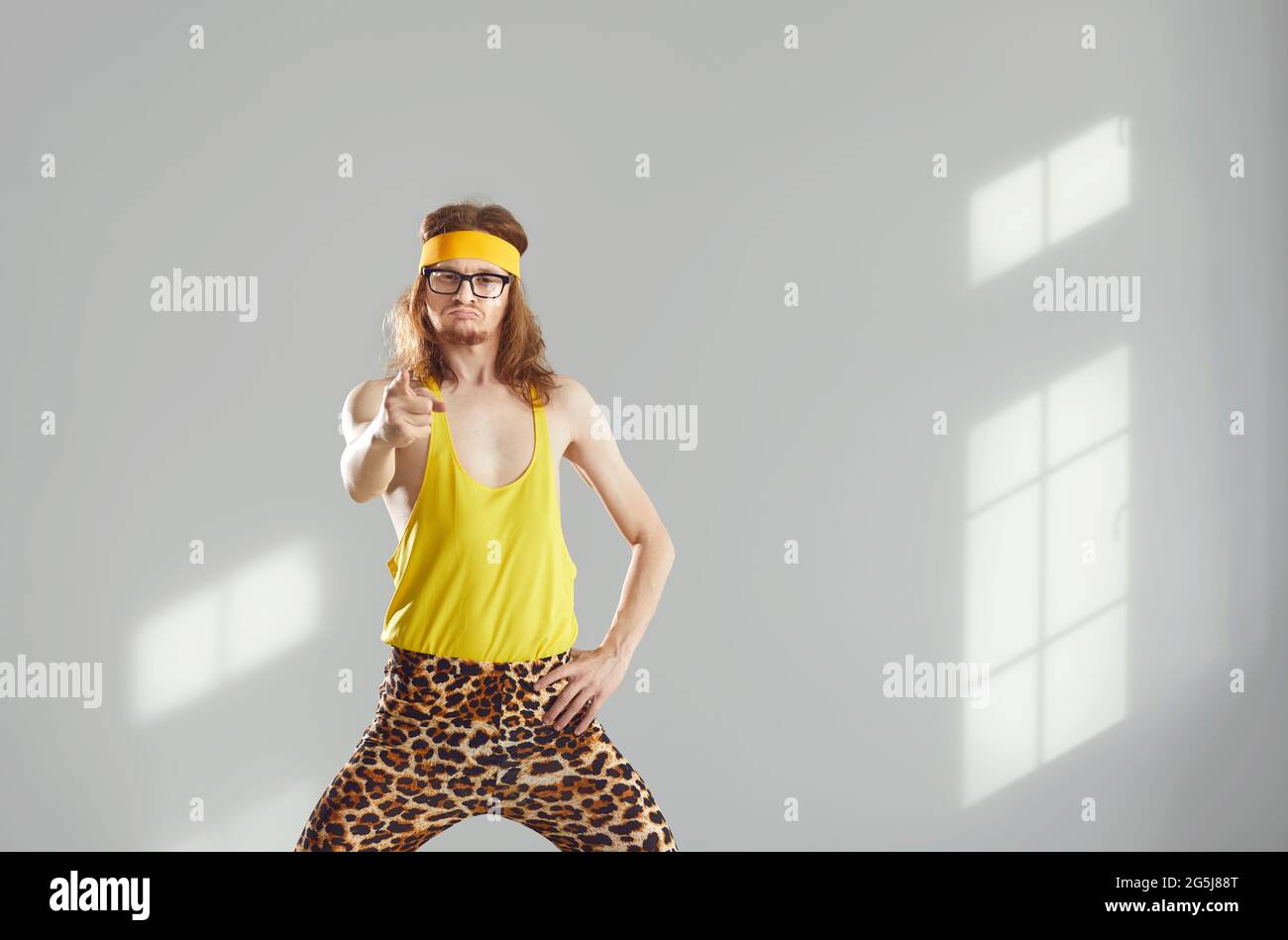 Fitness instructor in funny activewear pointing at camera with angry face expression Stock Photo