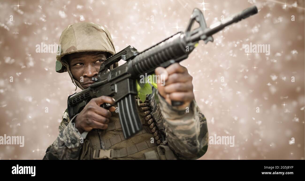 Composition of soldier firing gun, against motion blur brown background Stock Photo