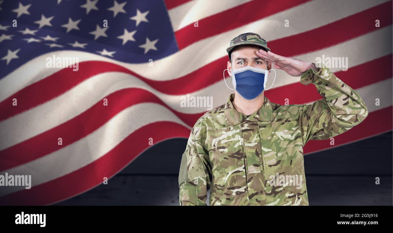 Composition of saluting soldier wearing face mask, against waving american flag, on black Stock