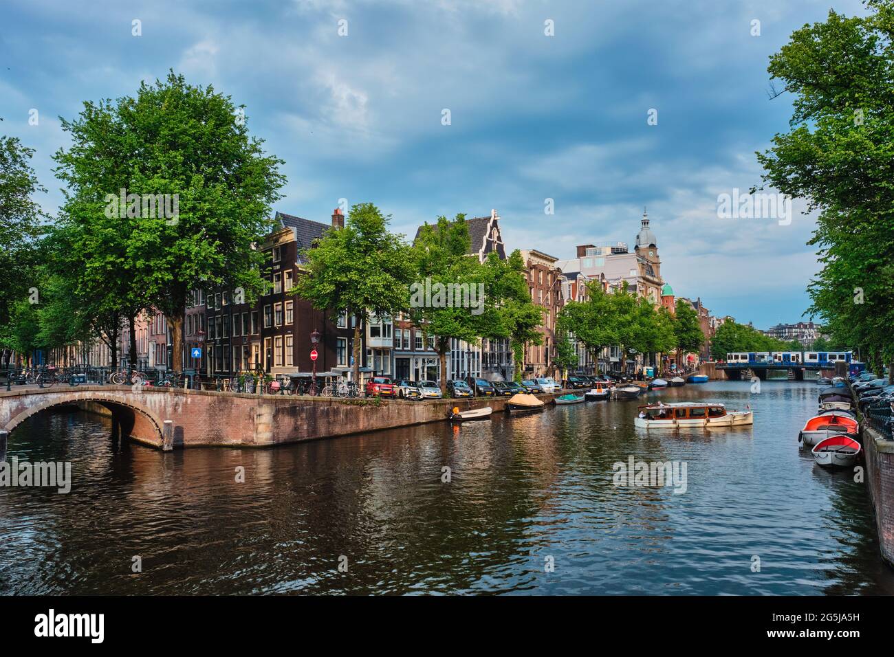 Amsterdam view - canal with boad, bridge and old houses Stock Photo