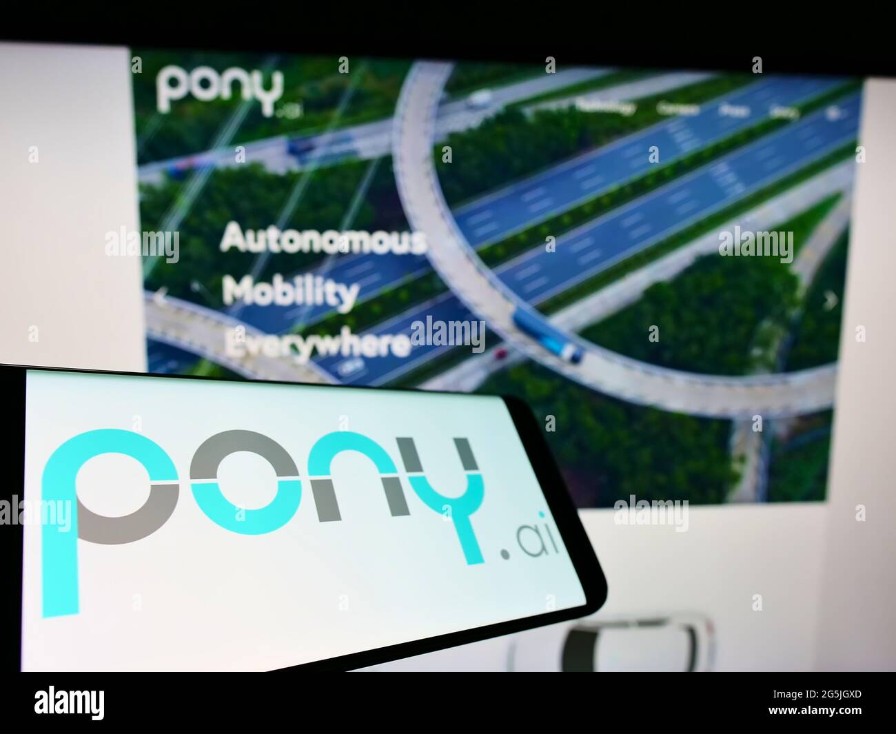 Cellphone with logo of autonomous vehicle company Pony.AI Inc. on screen in front of business website. Focus on center-left of phone display. Stock Photo
