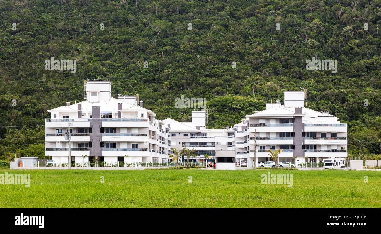 Picture of Apartment building near the forest and the mountain Stock Photo - Alamy