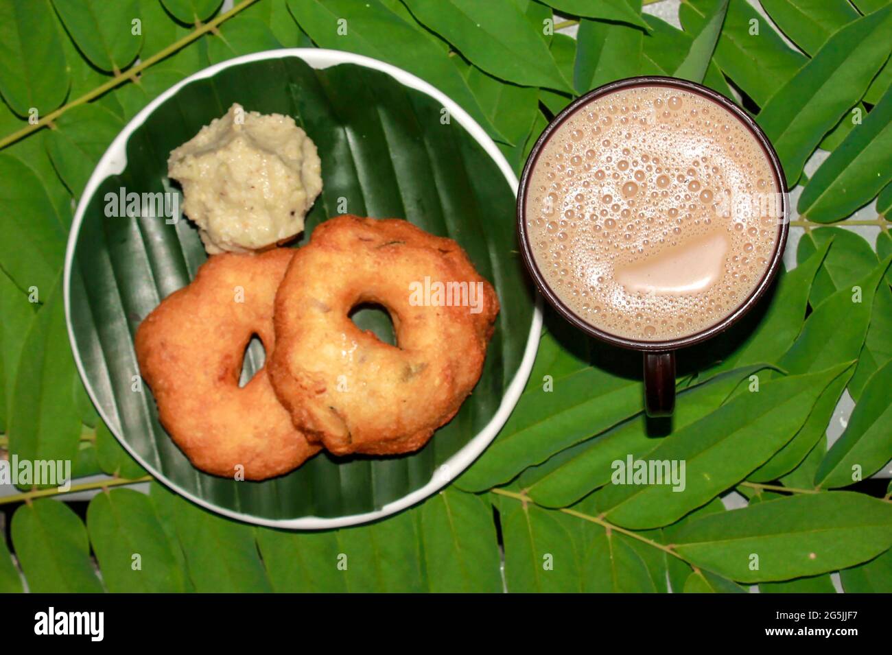 Tea with Indian snack image isolated on green background Stock Photo