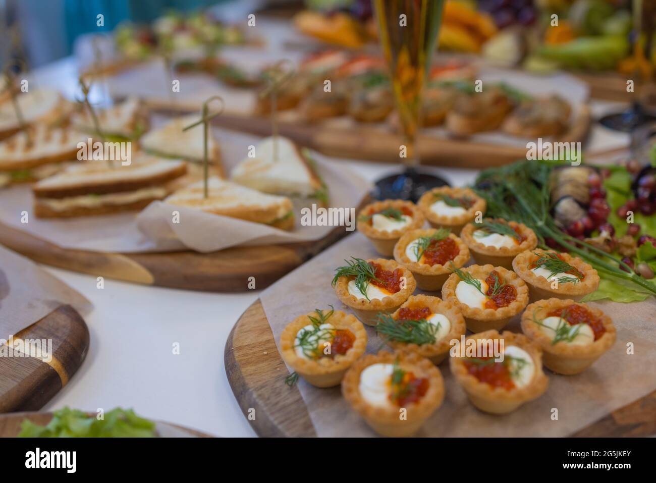Dinner table with snacks decorated with beautiful summer flowers. Food ...