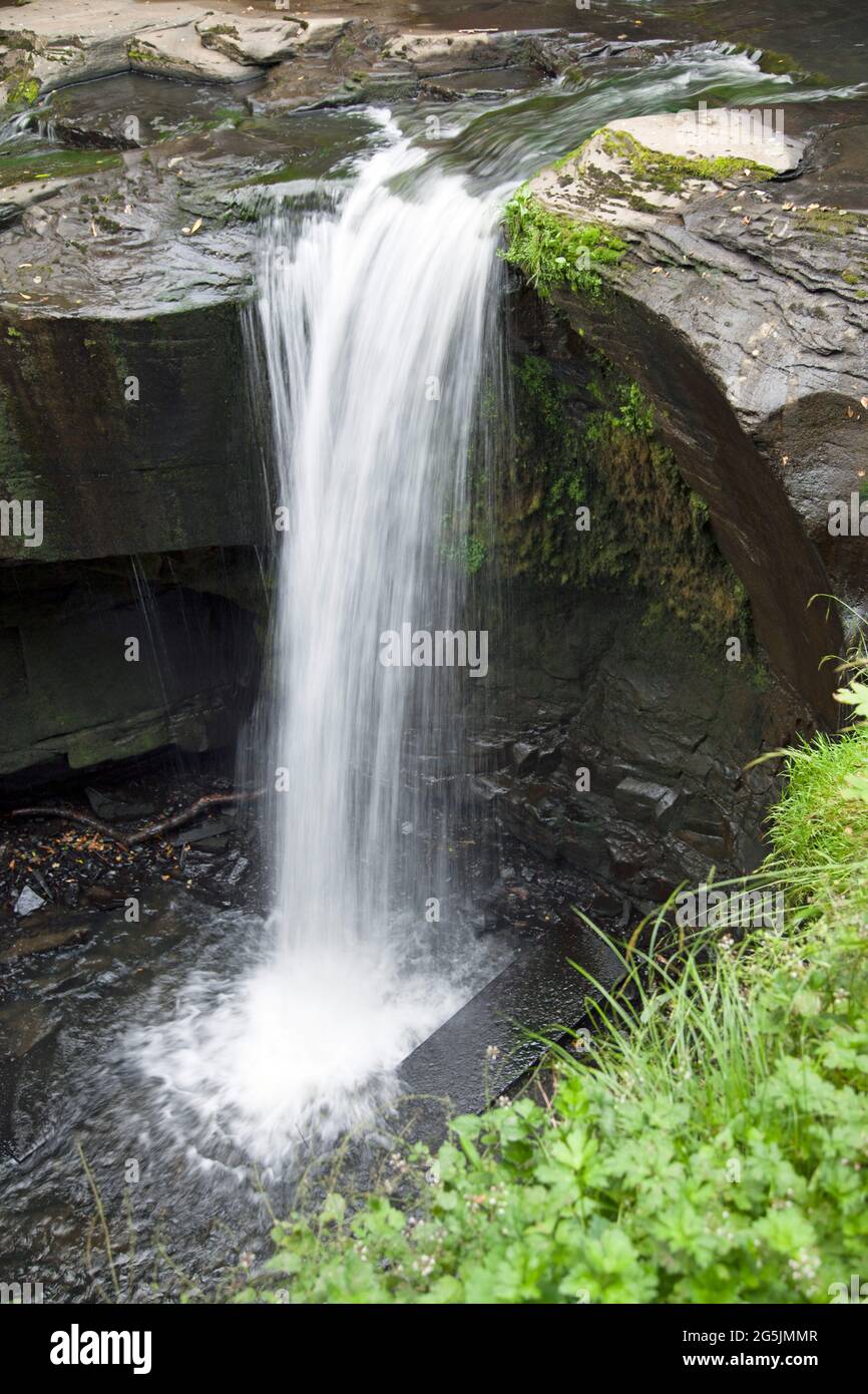Water flowing over a waterfall, Aberdulais, Neath, Wales, taken with a long exposure to show the water movement as it cascades down into a pool Stock Photo