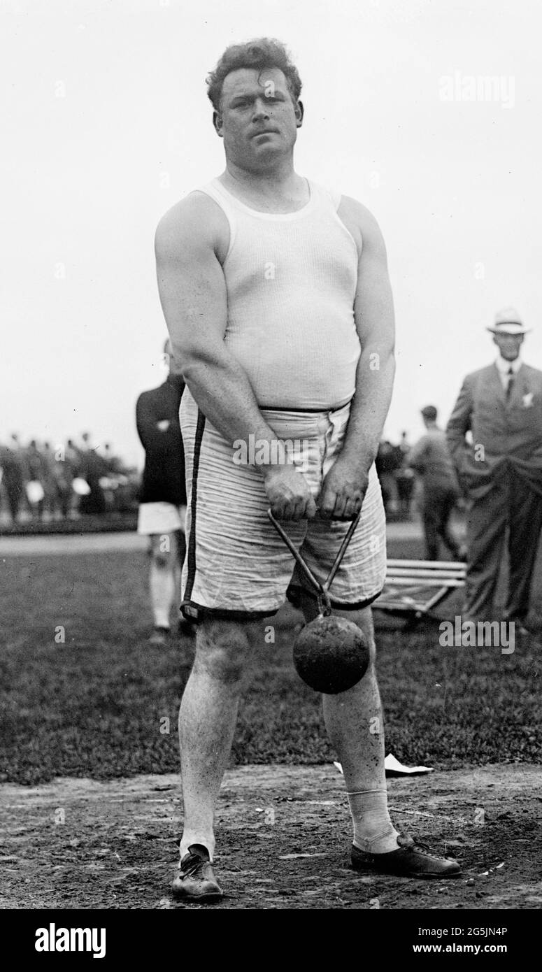 Matt McGrath holding a 56lb weight (1911) - He was an athlete representing America at the Summer Olympics, winning a Gold Medal in 1912 in Stockholm Stock Photo