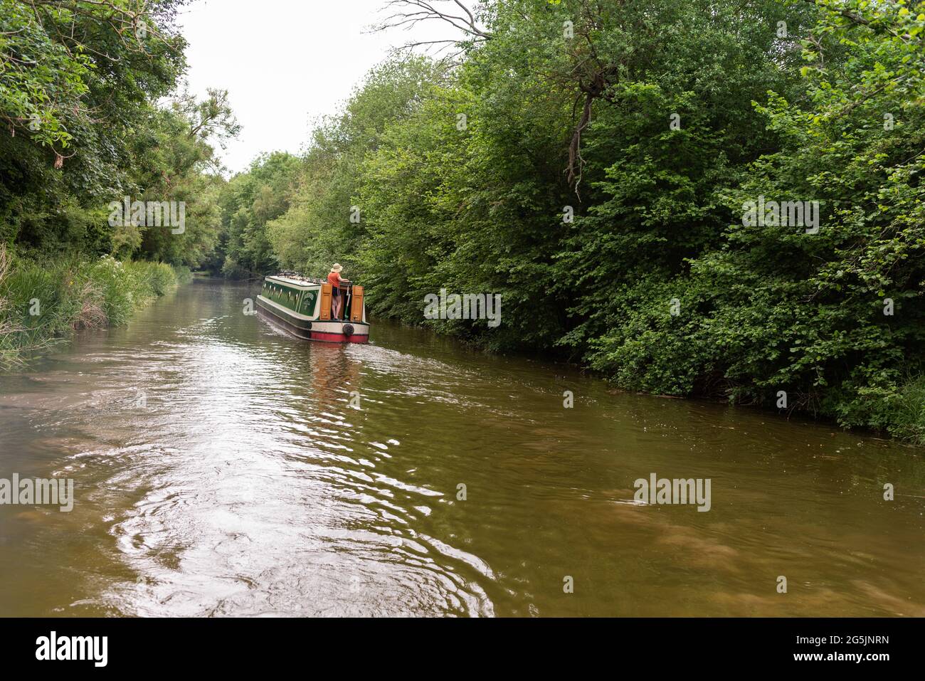 view from side of canal boat travelling down river Stock Photo