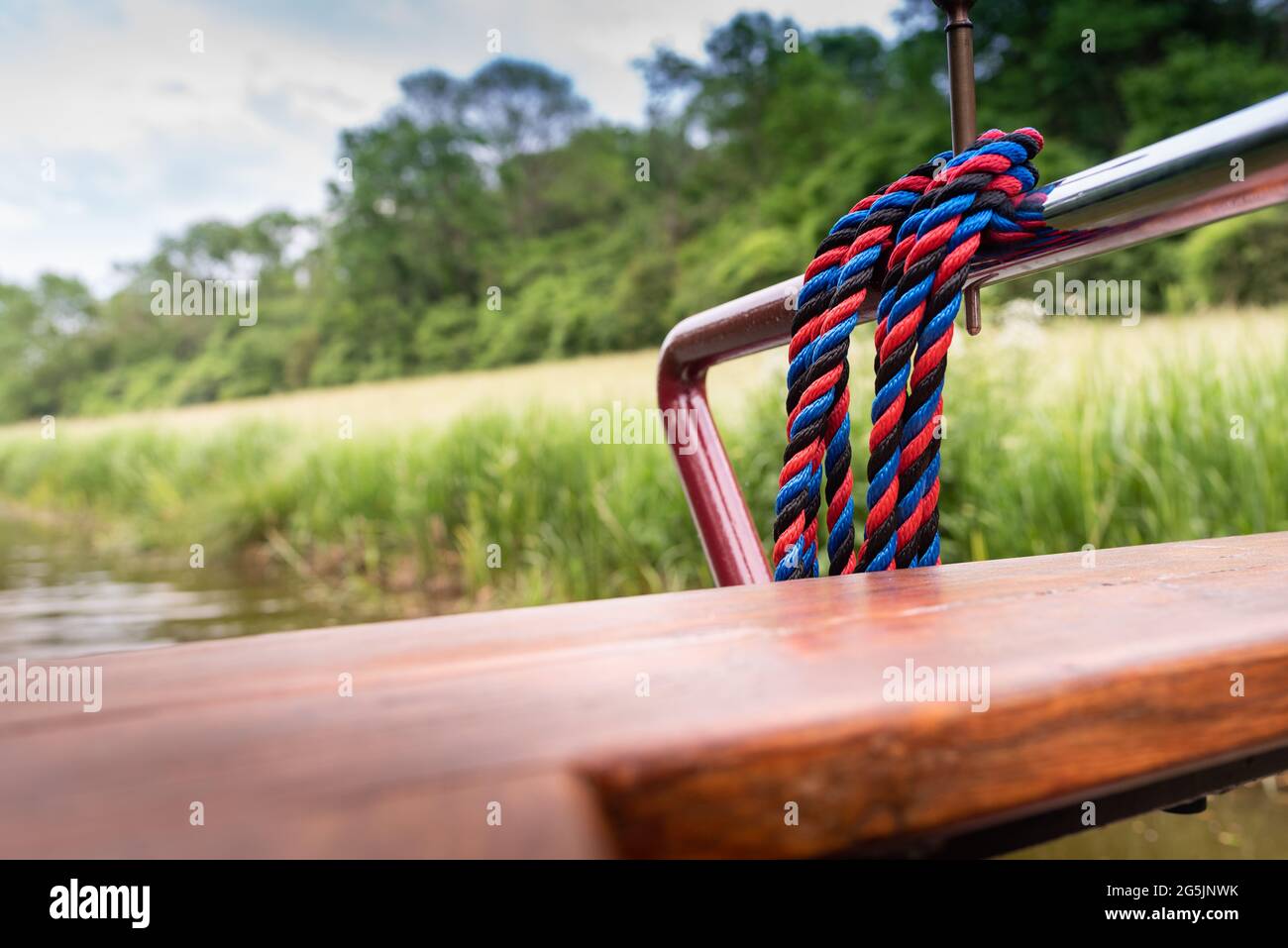 close up of rope on  canal boat tied to chrome rail Stock Photo