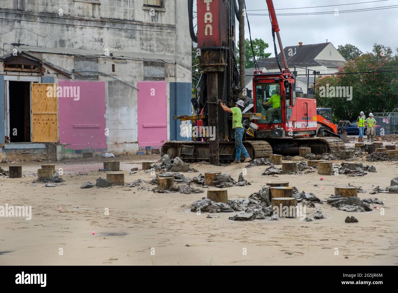 NEW ORLEANS, LA, USA - JUNE 22, 2021: Worker steadies piling for Industrial pile driver on Uptown construction site Stock Photo
