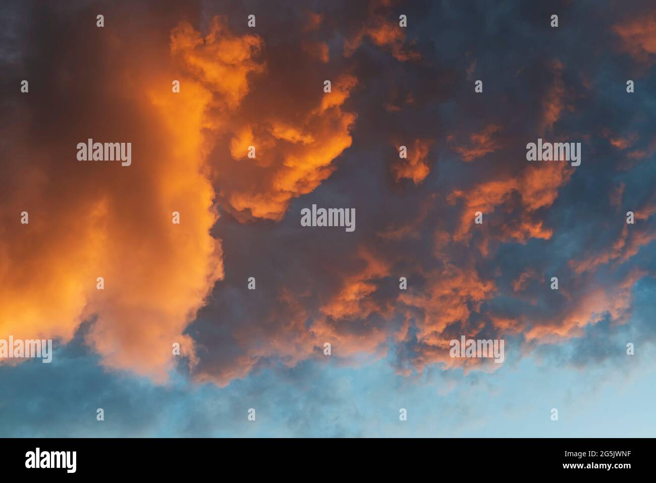 Dramatic clouds illuminated by sunset sun. Cloud background Stock Photo