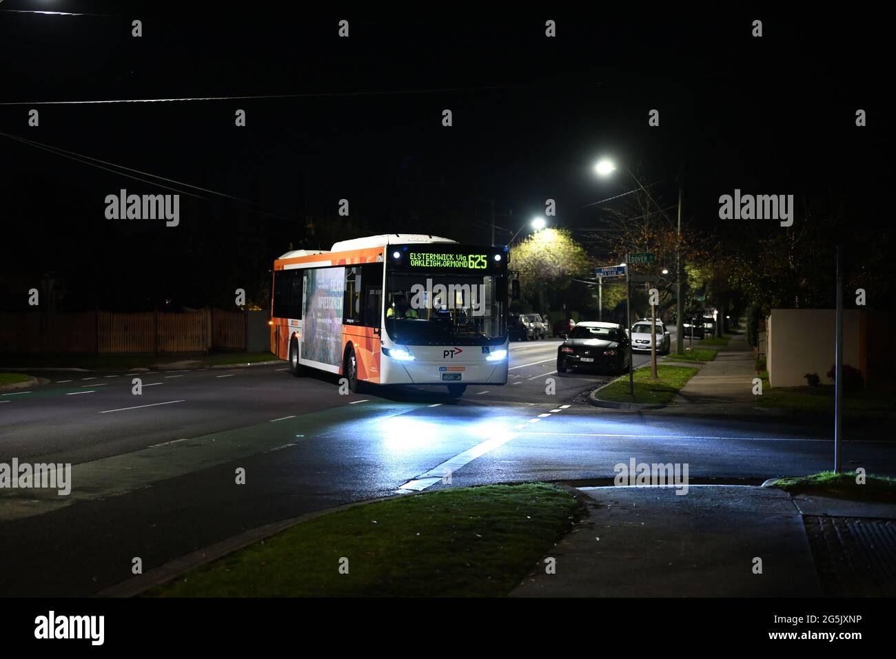 Route 625 bus, a Volgren model operated by CDC Melbourne, crosses Bambra Rd late at night on its way to Elsternwick Stock Photo