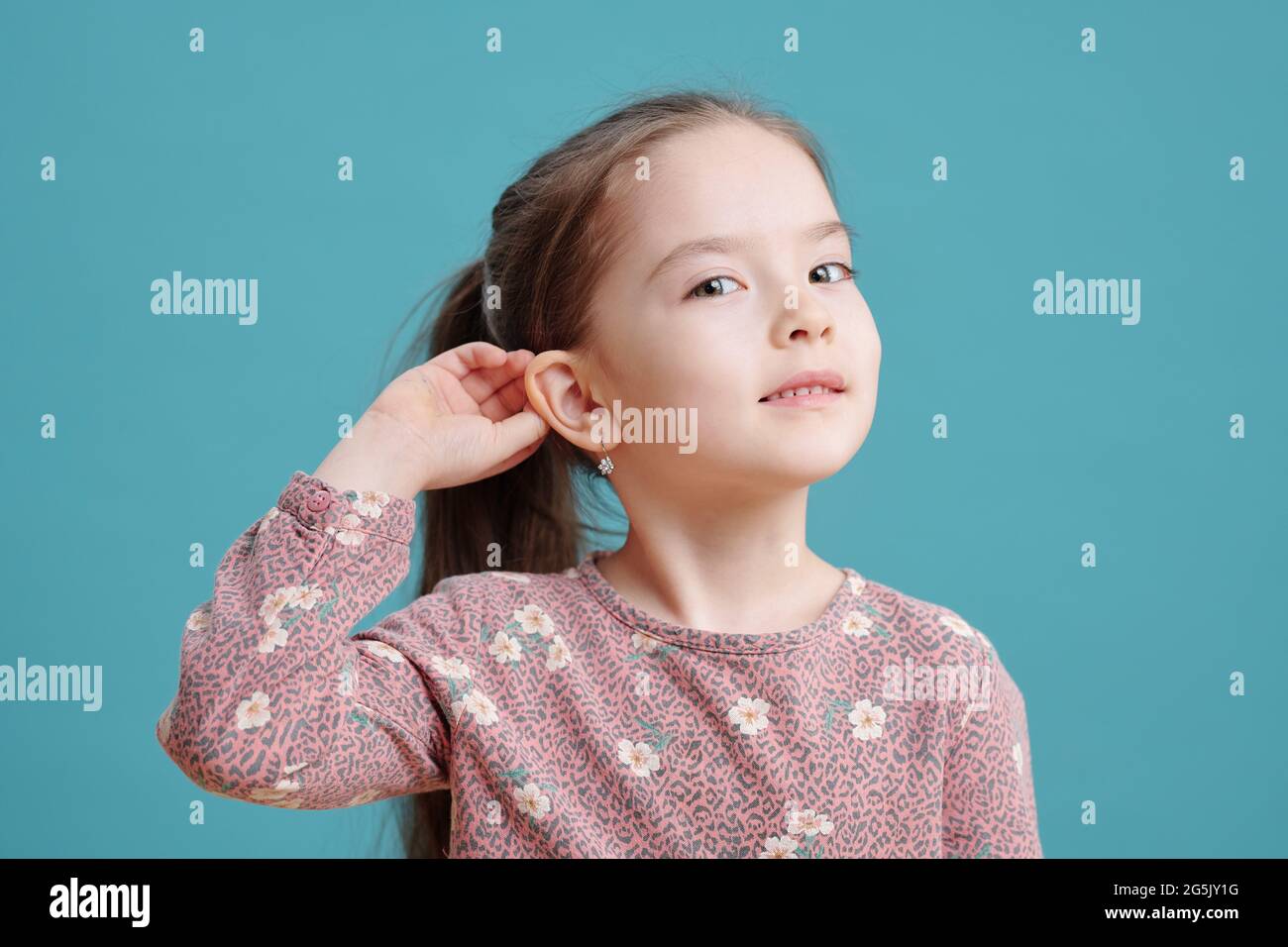 Cute little girl showing new earrings on ear Stock Photo Alamy