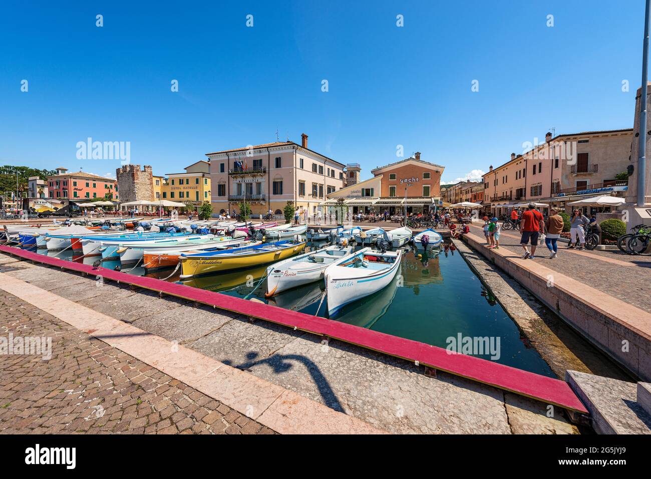 Port of the small village of Bardolino with fishing boats moored, tourist resort on the coast of Lake Garda (Lago di Garda). Verona, Veneto, Italy. Stock Photo