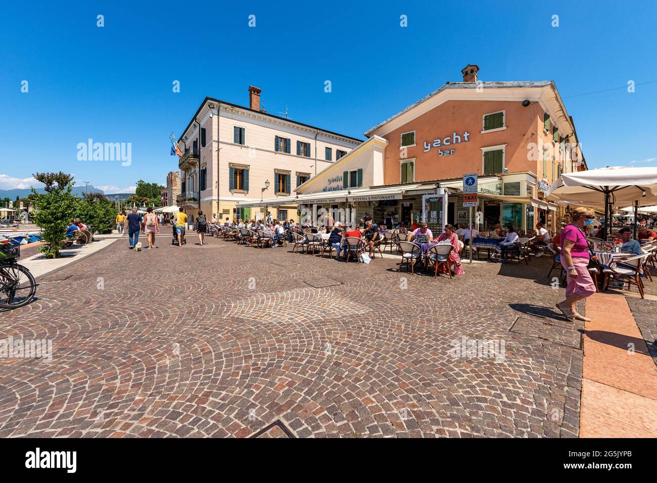 Bardolino village with a restaurant and pizzeria with many tourists, tourist resort on the coast of Lake Garda (Lago di Garda). Verona, Veneto, Italy. Stock Photo