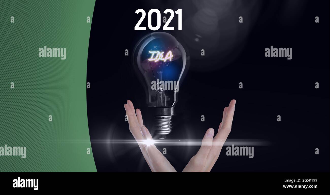 Composition of green copy space over year 2021, hand and idea in lightbulb, on black Stock Photo
