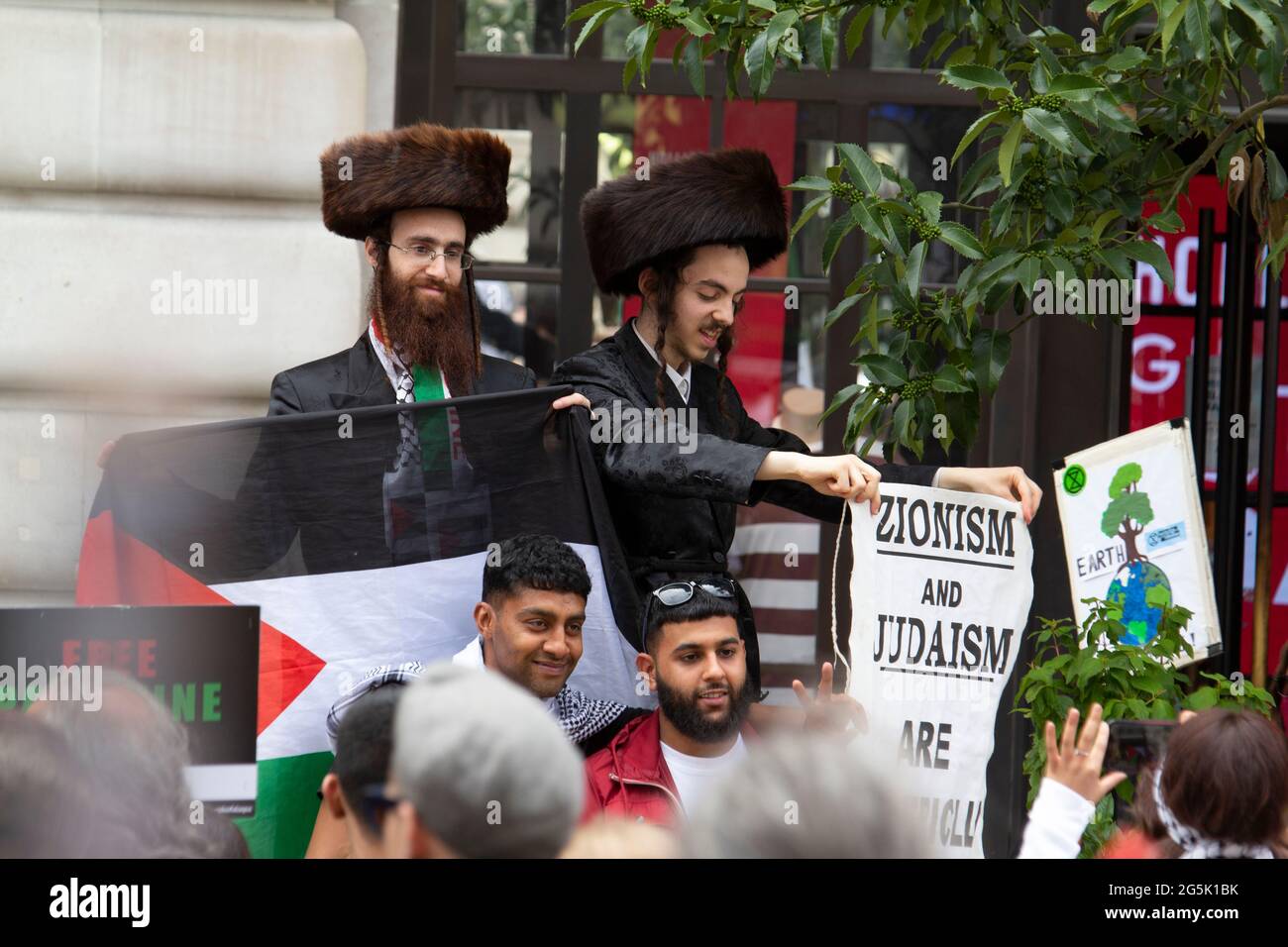 Ultra Orthodox Jews of the Neturei Karta division  from Stamford Hill who represent Orthodox Jews United Against Zionism amongst flags of Palestine attend  the People's Assembly National Demonstration in London. Rabbi Blyer is on left Stock Photo