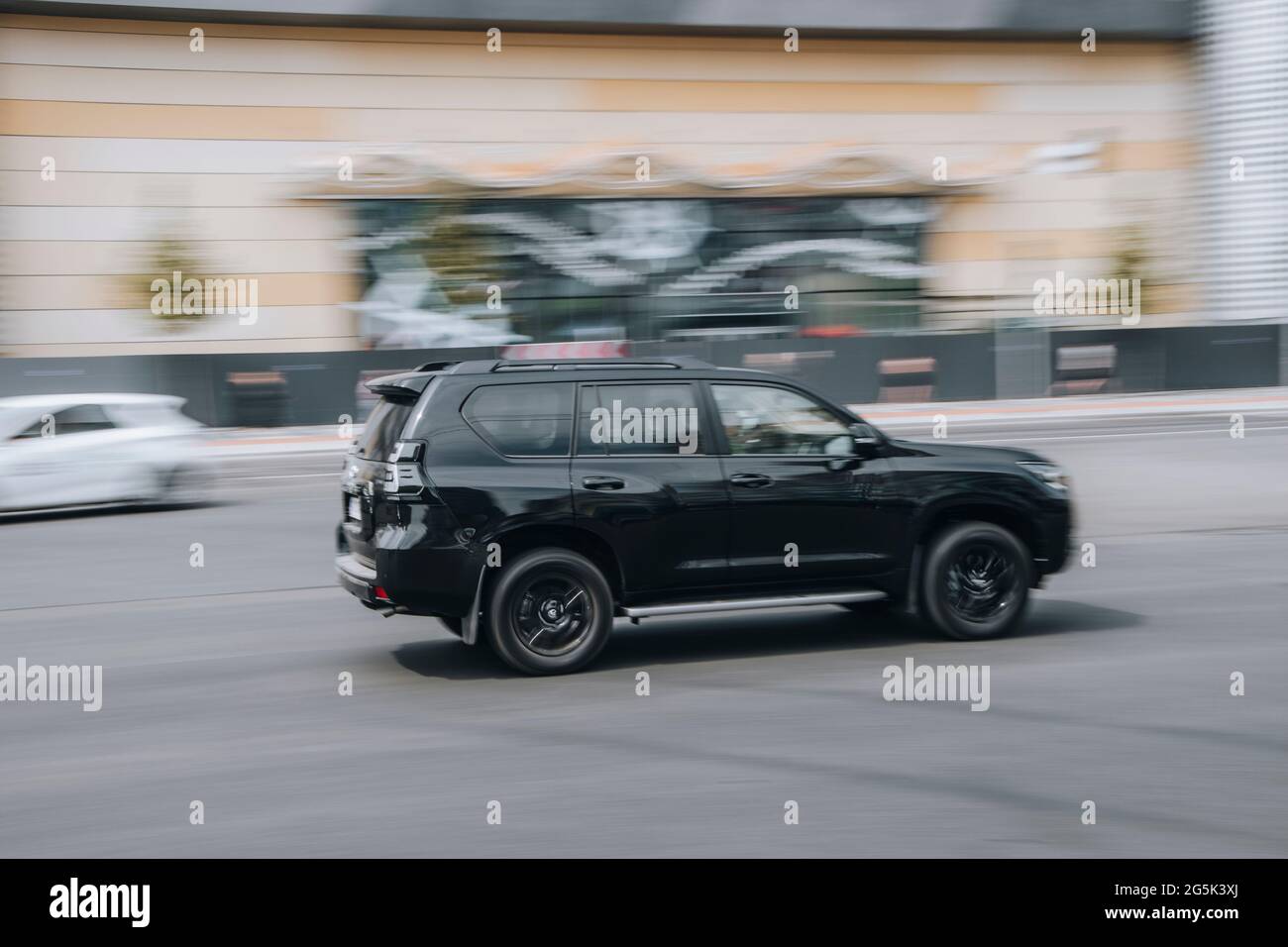 Ukraine, Kyiv - 27 June 2021: Black Toyota Land Cruiser Prado car moving on the street. Editorial Stock Photo