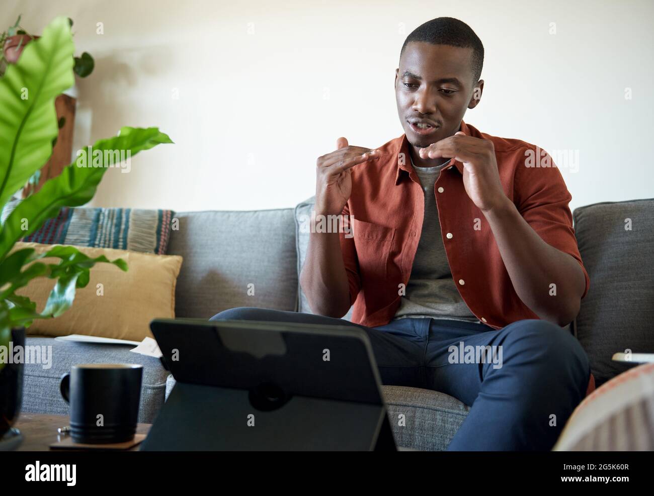 Young African man on a video call while working at home Stock Photo