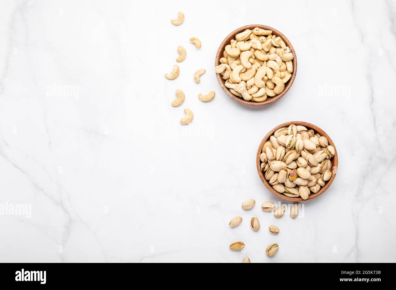 Cashew and pistachios nuts in wooden bowls Stock Photo