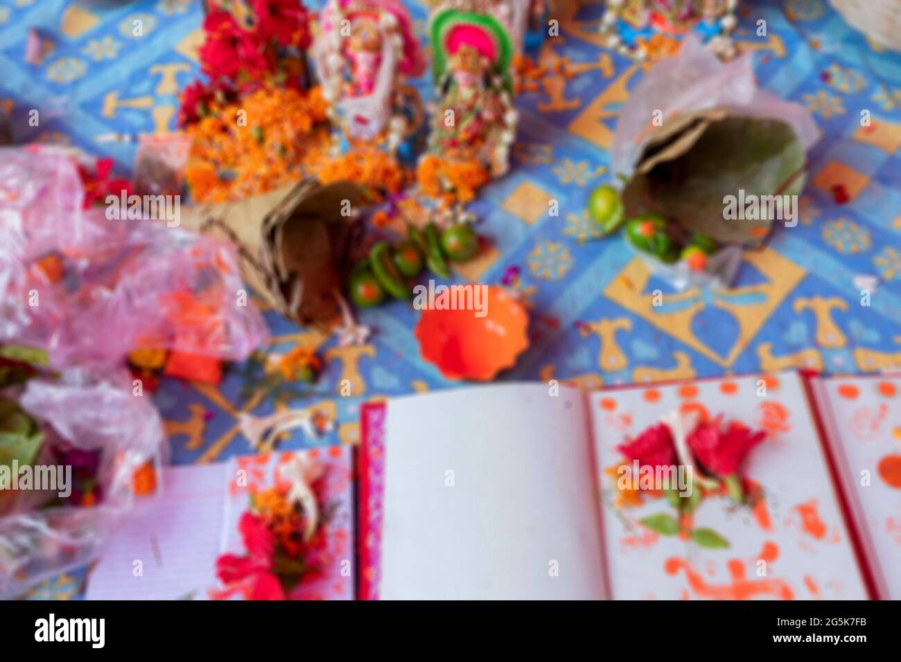 Blurred image of Goddess Laxmi, God Ganesh and new accounts book for new year, are being worshipped with flower and various other materials on auspici Stock Photo