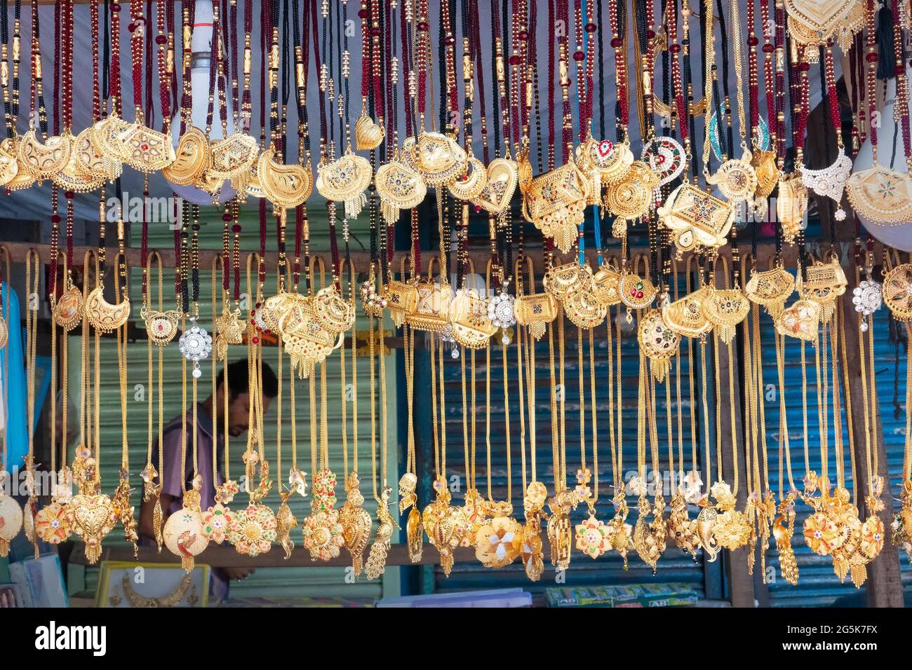 Kolkata, West Bengal, India - October 16th 2018 : Auspicious gold plated neck pieces are hanging for sale to Indian Bengali women. In Hinduism, gold s Stock Photo