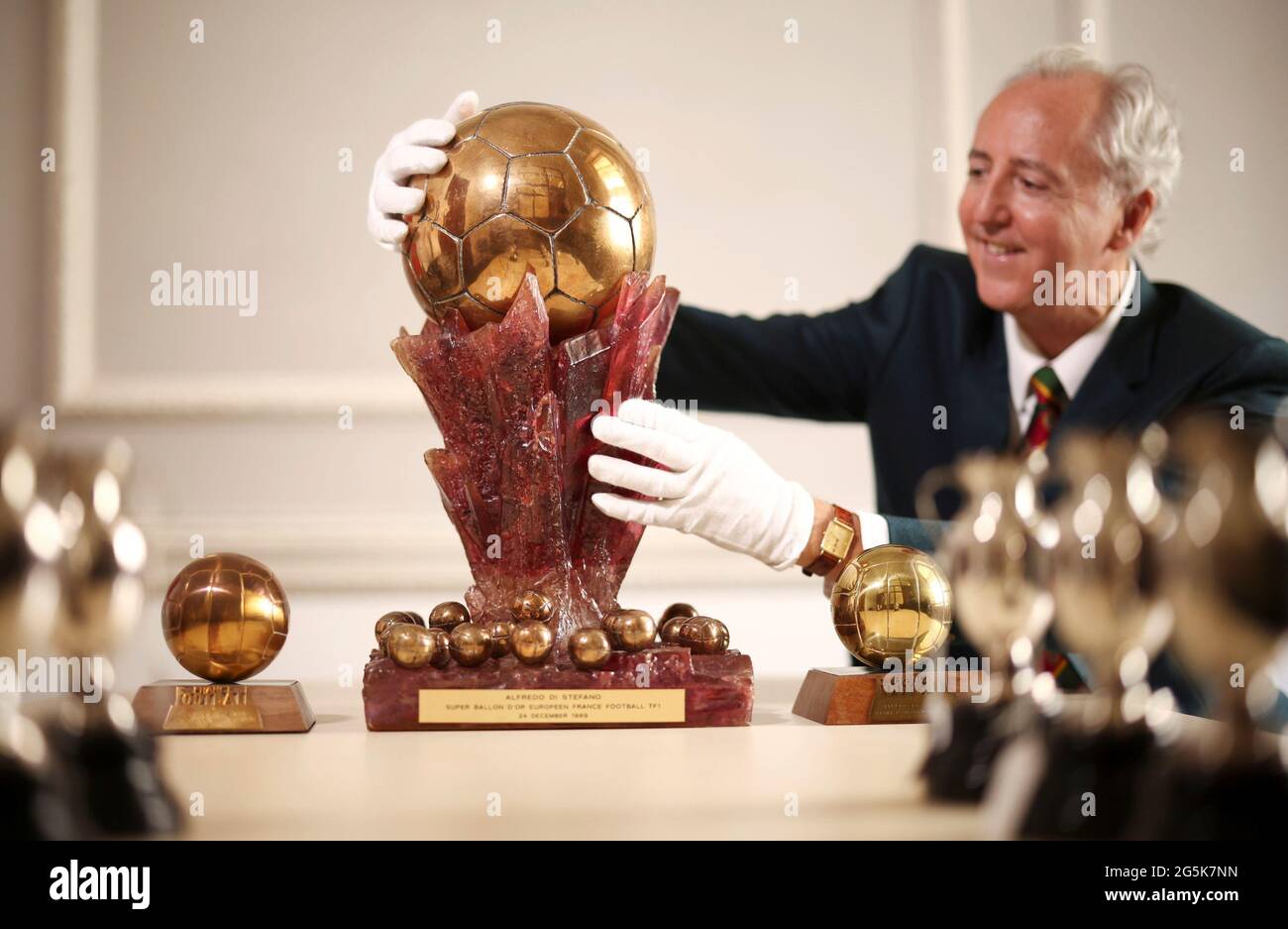 Executive Director Martin Nolan poses with the '1989 Super Ballon d'Or'  from the 'Property from the estate of Alfredo Di Stefano' collection, at  Julien's Auctions in London, Britain, June 25, 2021. Picture