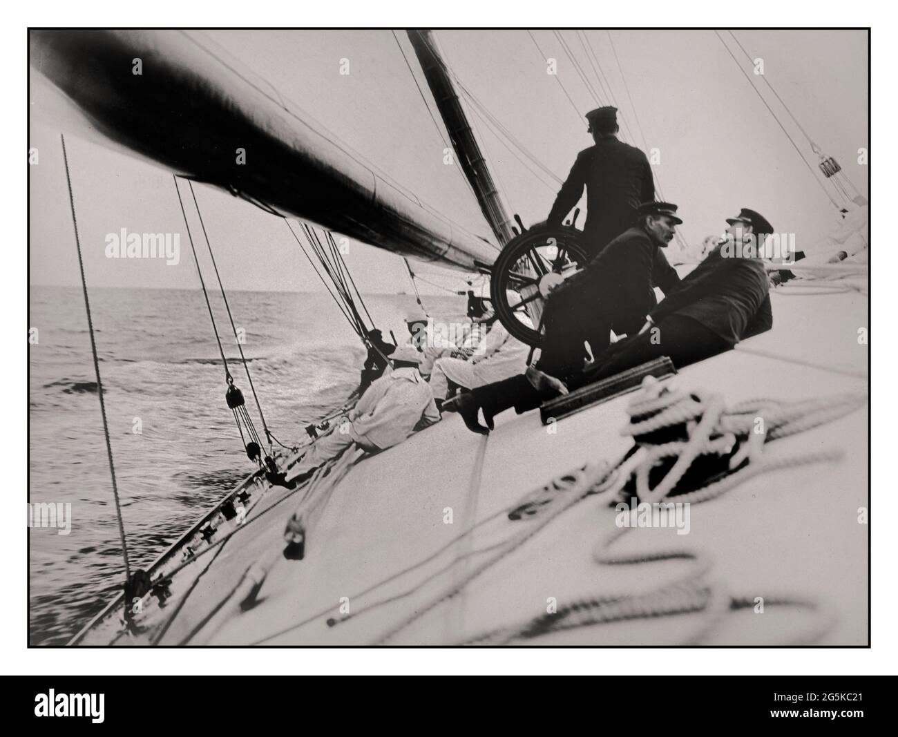 AMERICAS CUP WINNER 1903  crew lying on tilting deck of the yacht Reliance, winner of 1903 America's Cup Photograph shows gaff cutter designed by Nathanael Greene Herreshoff and built by Herreshoff Manufacturing Company, Bristol, Rhode Island, for the 1903 America's Cup. Burton, James, photographer [1903] -  Reliance (Yacht)--1900-1910 -  America's Cup--(12th :--1903 :--New York, N.Y.)--Equipment & supplies -  Sailboats--American--1900-1910-  Yachts--American--1900-1910  Sailing--1900-1910 Stock Photo