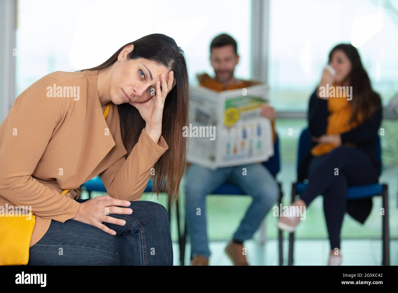 bored female applicant sitting in waiting room Stock Photo Alamy