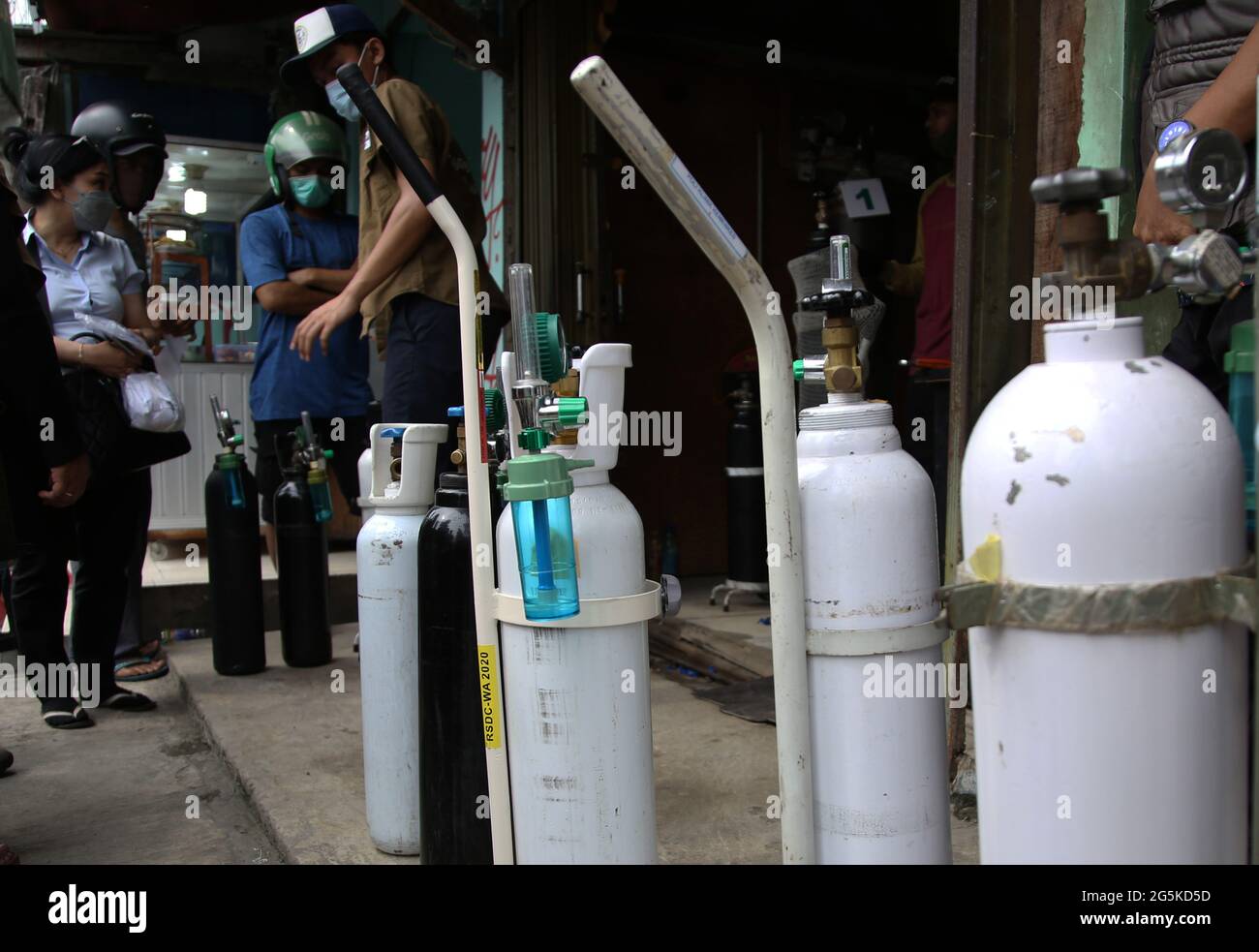 Jakarta, Jakarta, Indonesia. 28th June, 2021. Residents queue for filling oxygen gas cylinders in Manggarai, Jakarta, on June 28, 2021. The demand for new oxygen cylinders and filling oxygen cylinders has increased drastically following the surge in Covid-19 cases in DKI Jakarta and currently oxygen cylinders are becoming scarce in the market so that refilling oxygen is also an option even though residents have to queue. Credit: Dasril Roszandi/ZUMA Wire/Alamy Live News Stock Photo
