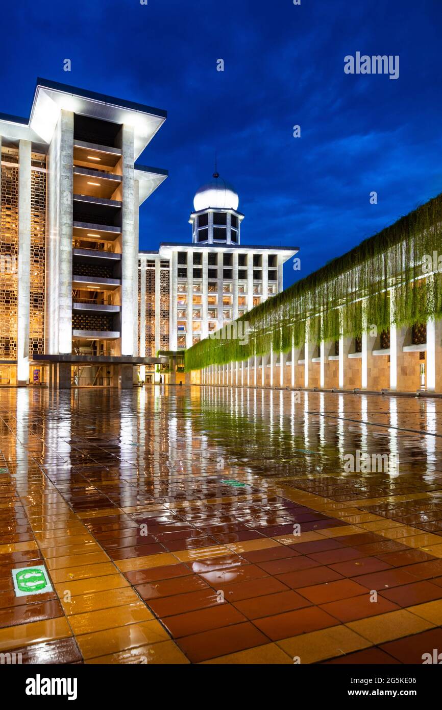 Jakarta, Indonesia - CIRCA June 2021: Exterior of the new Istiqlal Mosque in Jakarta, after renovation in the year 2020, in rainy sunset (blue hour) Stock Photo