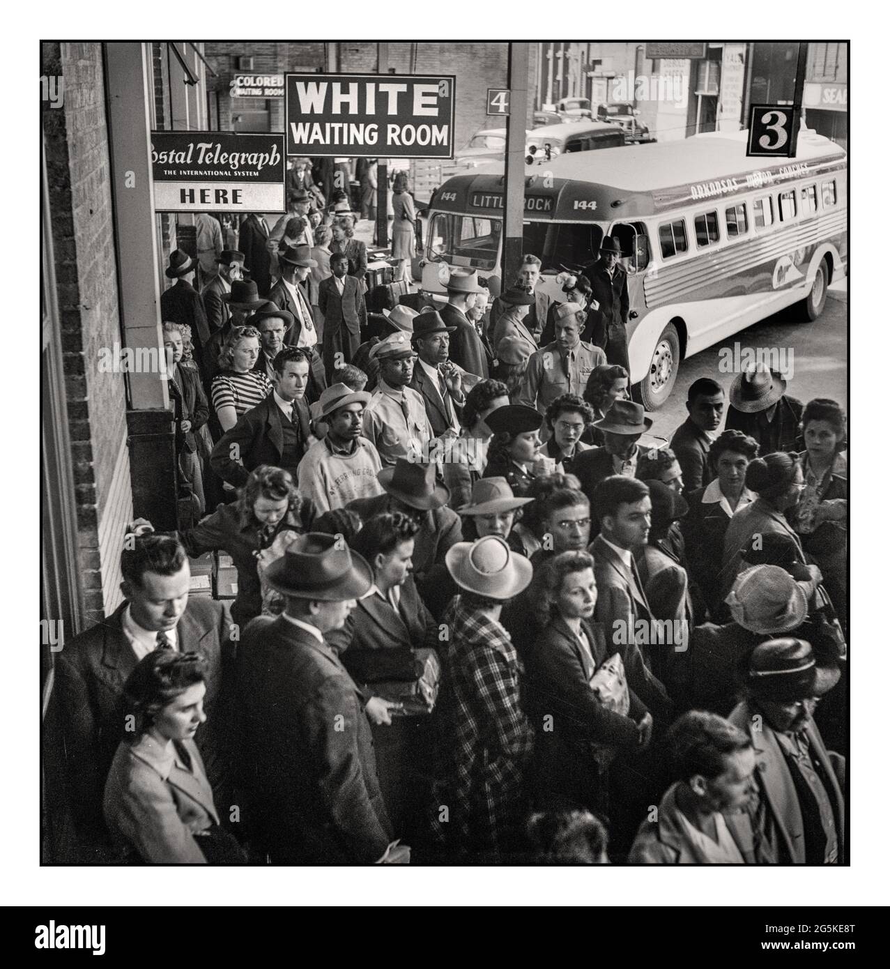 Racial Racist Segregation USA travel signs ‘white/coloured’ at the bus terminal during WW2 'WHITE WAITING ROOM' A Greyhound bus Racial Racist Segregation signs at the bus terminal trip from Louisville, Kentucky, to Little Rock Arkansas at the terminals. Caucasian crowds at the front waiting for a bus at the Memphis station with segregation signs above. Esther Bubley, photographer World War II 1943 Sept. Stock Photo