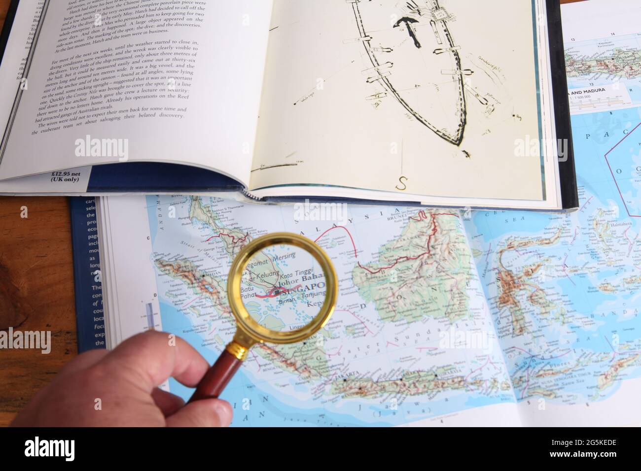 Looking at location of Geldermalsen shipwreck The Nanking Cargo in atlas of South China Sea, book by Michael Hatcher, Max De Rham Antony Thorncroft Stock Photo